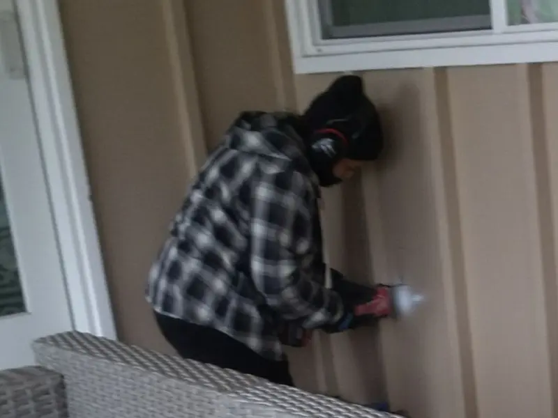 Professional electrician installing an exterior outlet in Derby